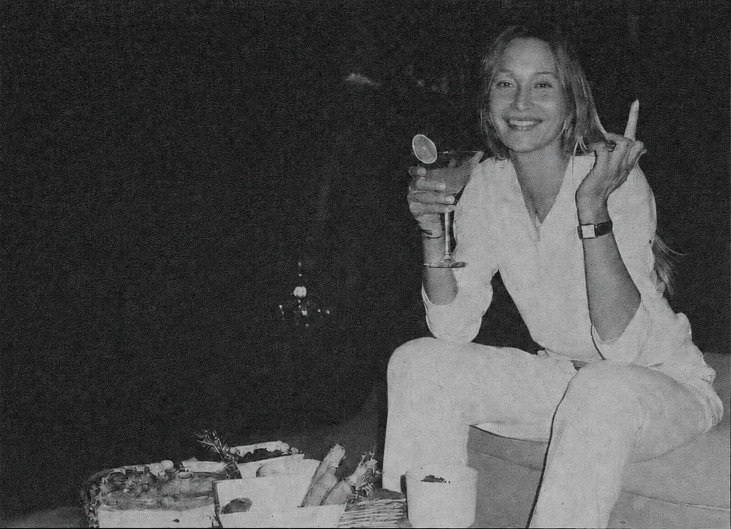 A woman smiling and holding a cocktail glass at Ū Villas